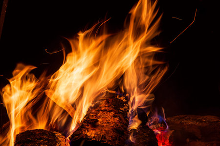 Night campfire with available space. Big bonfire against black background. Sparks of bonfire and...