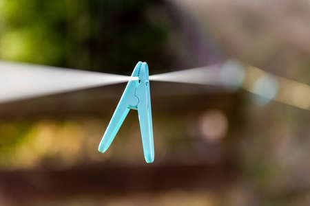 clothespins on a clothesline outdoor in courtyard of rural house. close up horizontal photoの写真素材