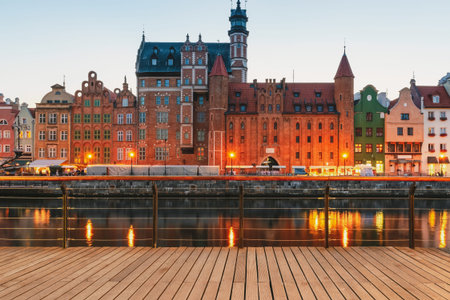 Facades of old medieval houses on the promenade in Gdansk city. Poland. Riverside view from wooden...