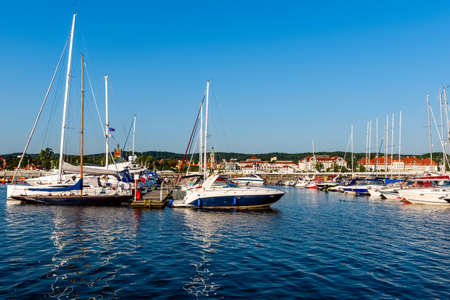 Sailing yachts moored on a pier in a harbor on baltic sea in a sunny morning. Nautical vessel for charterの写真素材