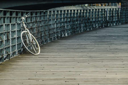 Bicycle on the pier. Old white rusty bicycle park at the wooden pier.の写真素材