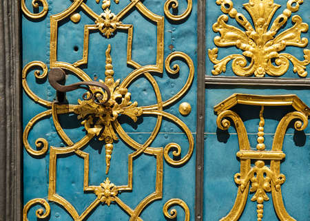 fragment of blue and golden old carved metal gate, entrance to old universityの写真素材