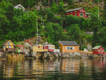 Small colorful fish boat houses in Oslo fjord in Norway. Oslo fjord shore and classical scandinavian tiny wooden housesの写真素材