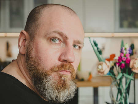 portrait of an adult bearded man at home with copy spaceの写真素材