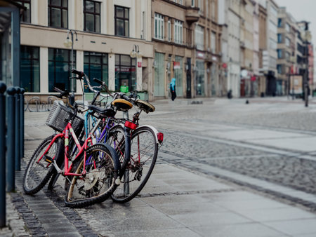 abandoned broken obsolete three bicycles on city street in a rainy day