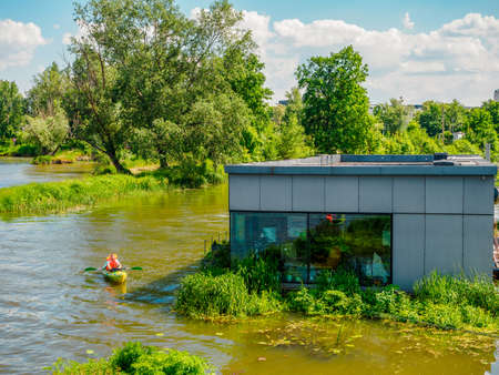 floating house or house on water in a reeds on a river in a city, contemporary livingの写真素材