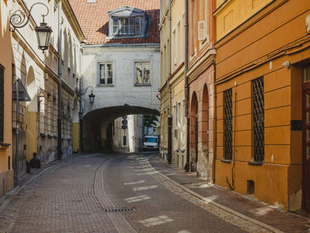 old cobblestone narrow street in historic district of Warsaw city, Polandの写真素材