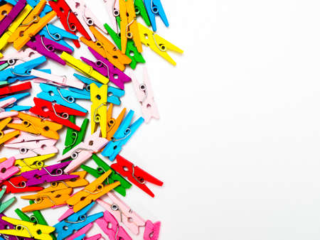 frame from multi colored wooden decorative clothespins, horizontal photo with place for text on white background and copy spaceの写真素材