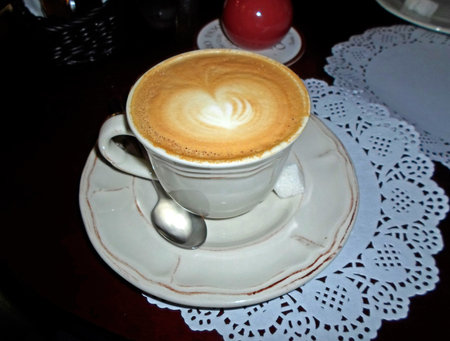 Cappuccino in the vintage cup on the tableのeditorial素材