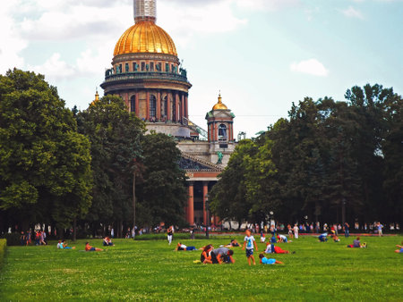 People are resting in the park next to the Saint Isaac's Cathedral in Saint Petersburg, Russia - June 2016のeditorial素材