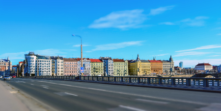 View on the Prague colorful buildings from the bridge across the Vltava on bright, sunny summer day. Diorama effectのeditorial素材
