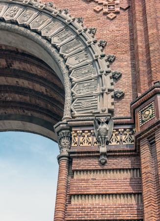 Stone bats on pillars of the red brick Arc de Triomf (triumphal arch) in Neo-Mudejar style in Barcelona, Spain. Bats were the emblem of King Jaume I, who ruled over a period of prosperity in Barcelonaの写真素材