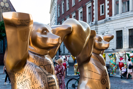 Riga, Latvia - July 15, 2018: 'Golden Rule' bears at United Buddy Bears international art exhibition (Artist: Eva Herlitz). This symbolises that nobody can live on his or her own.のeditorial素材