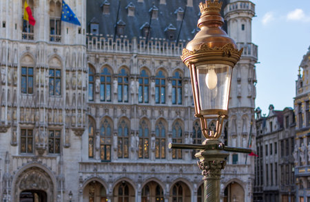 Vintage street lamp with the Gothic  Brussels Town Hall in the background on the famous Grand Place in Brussels, Belgium.の写真素材