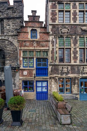 Ghent, Belgium - December 16, 2018: The tiny Tolhuisje (House of Tonlieu) with bright blue door and windows. It is the smallest house in Ghent, which stands on the Graslei.のeditorial素材