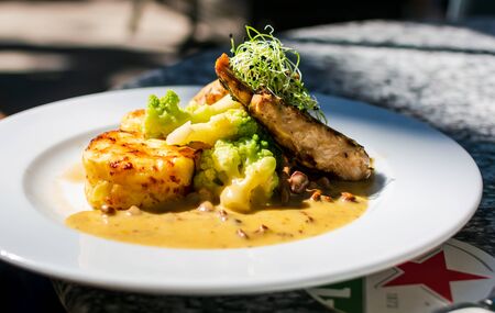 Chicken breast with chanterelle, fried potatoes, cauliflower and under cream sauce. Restaurant serving.の写真素材