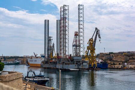 Cospicua, Malta - September 1, 2019: Cranes in the Palumbo dockyards in Cospicua, one of which was turned to a massive metal Giraffe by Maltese artist as part of Valletta 2018âs visual arts exhibitionのeditorial素材