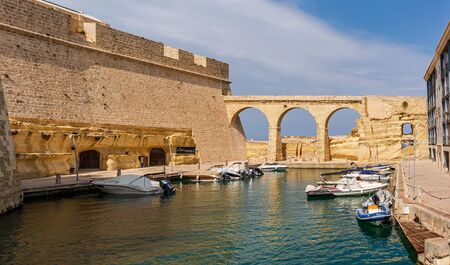 Birgu, Malta - September 1, 2019: The ditch turned into moat that separates Fort St Angelo from Birgu.のeditorial素材