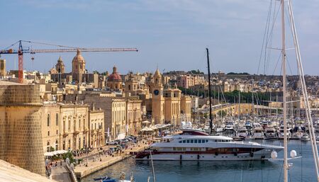 Birgu, Malta - September 1, 2019: Yachts and boats anchored at Grand Harbour Marina of Birgu (Vittoriosa) in Malta, with embankment and Maritime Museum building.のeditorial素材