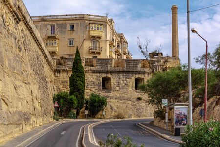 Cospicua, Malta - September 1, 2019: Fortified walls in Bormla with green bushes and trees.のeditorial素材