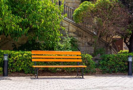Bright yellow bench in Independence Gardens park in Sliema, Malta. This recreation area located near the sea and equipped with paths, playgrounds, cafes and fountain.の写真素材