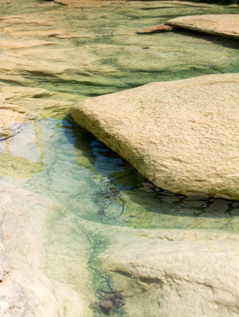 Blue emerald sea water with stones at the beach in Sliema, Malta. Unearthly rocky Malta shore.の写真素材