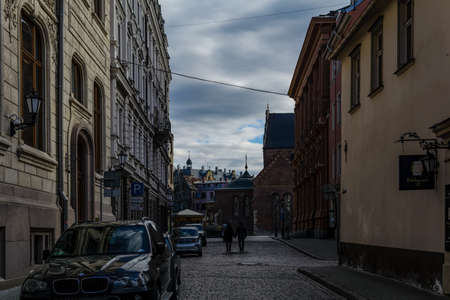 Riga, Latvia - April 5, 2020: Young couple walking down the empty Old Town's street in Coronavirus quarantine period. City center in coronavirus COVID-19 pandemic quarantine time.のeditorial素材