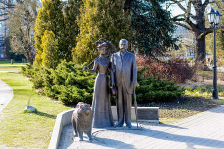 Riga, Latvia - April 5, 2020: Statue of George Armitstead, fourth Mayor of Riga, his wife Cecile and their Chow-Chow dog. Statue was unveiled by Queen Elizabeth II in Latvian National Opera gardens.のeditorial素材