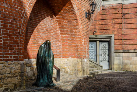 Riga, Latvia - April 5, 2020: The Ghost bronze sculpture by Ieva Rubeze in Old Town near medieval defence wall.のeditorial素材