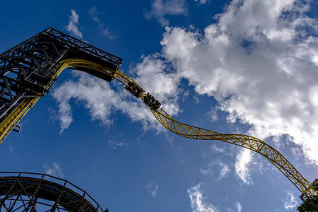 Helsinki, Finland - August 23, 2020: Train with 2 cars with people at Ukko roller coaster rail track in amusement park Linnanmaki. Currently the second tallest and fastest roller coaster in Finland.のeditorial素材