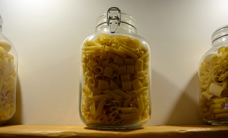 Pasta mix in a glass jar. Cannelloni, Sedani, Mezze maniche and Penne pasta mixed together in one...