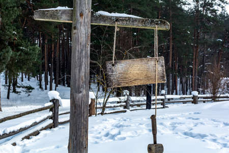 Wooden plate and a hammer used as a watchman rattle in old Latvian settlement yard.の写真素材