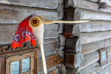 Doll in MeteÅi mumming mask and costume of stork, wearing red kerchief. Meteni is ancient Latvian spring waiting holiday, when mummers scare the winter.の写真素材