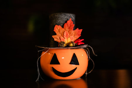Halloween pumpkins with black witch hat on its, Wooden background. Jack-o-lantern on the celebration...