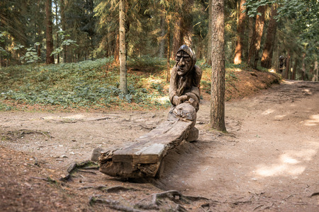 JUODKRANTE, LITHUANIA - AUGUST, 2018: Traditional Lithuanian Raganu kalnas wood carving art sculptures of folk musicians in public nature park in Juodkrante, Lithuaniaのeditorial素材