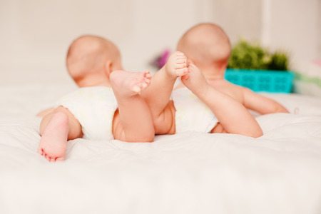 Feet of baby tweens in parent's handsの写真素材