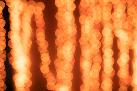 Yellow Christmas Tree Bokeh on black background of defocused glittering lights, Christmas background...