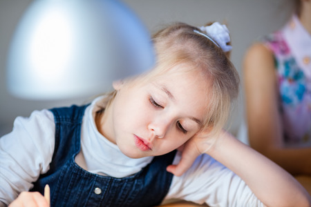 the portrait of little blonde girl at the workshop on gingerbread decorating.の写真素材