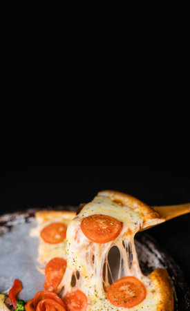 Delicious cheese stringy slice lifted of full supreme pizza margarita baked fresh out of the oven....