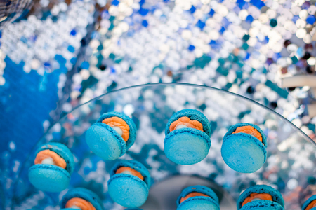 Candy bar, contains fruits, cup cakes, chocolate and another sweet desserts. Banquet service. Catering buffet style. Macaroons shell with pearls sharesの写真素材