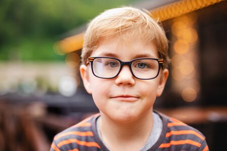 Young elementary boy with blonde hair and glasses.の写真素材
