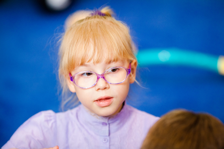 Young girl is ready to start school in a uniform wearing a backpack.の写真素材