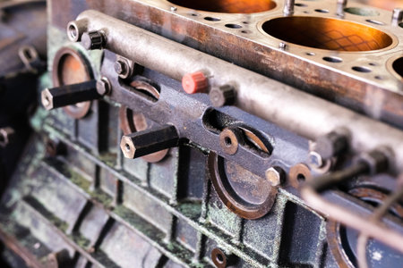 Mechanic repairs old motor of truck in a car repair station. Disassemble engine block vehicle. Motor...