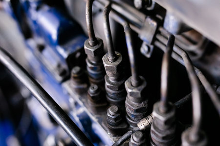 Mechanic repairs old motor of truck in a car repair station. Disassemble engine block vehicle. Motor...