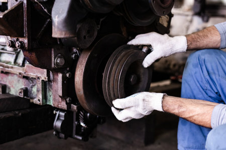 Mechanic repairs old motor of truck in a car repair station. Disassemble engine block vehicle. Motor...