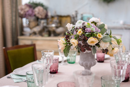 bouquet of flowers in a vase at the wedding table.