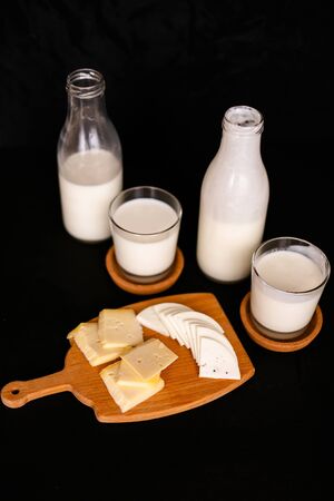 Fresh dairy products on an old kitchen board. Black backgroundの写真素材