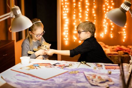 Little blonde bou and girl and their mother writes the letter to Santa.の写真素材