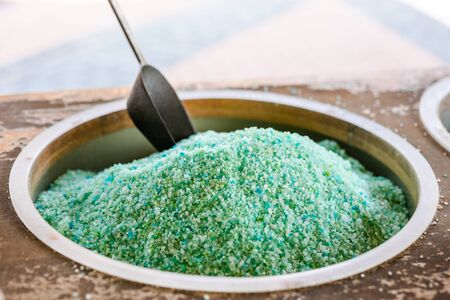 Dead Sea colorful salt and scoop on a buckets at a souvenir shop in Kalia Beach, West Bankの写真素材