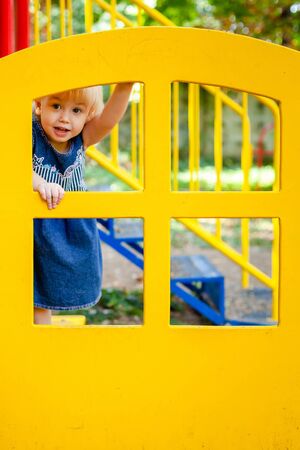 Portrait of baby 1-2 years old. Happy caucasian child girl playing toys at the playground. Girl smiling. Kids and sport conceptの写真素材